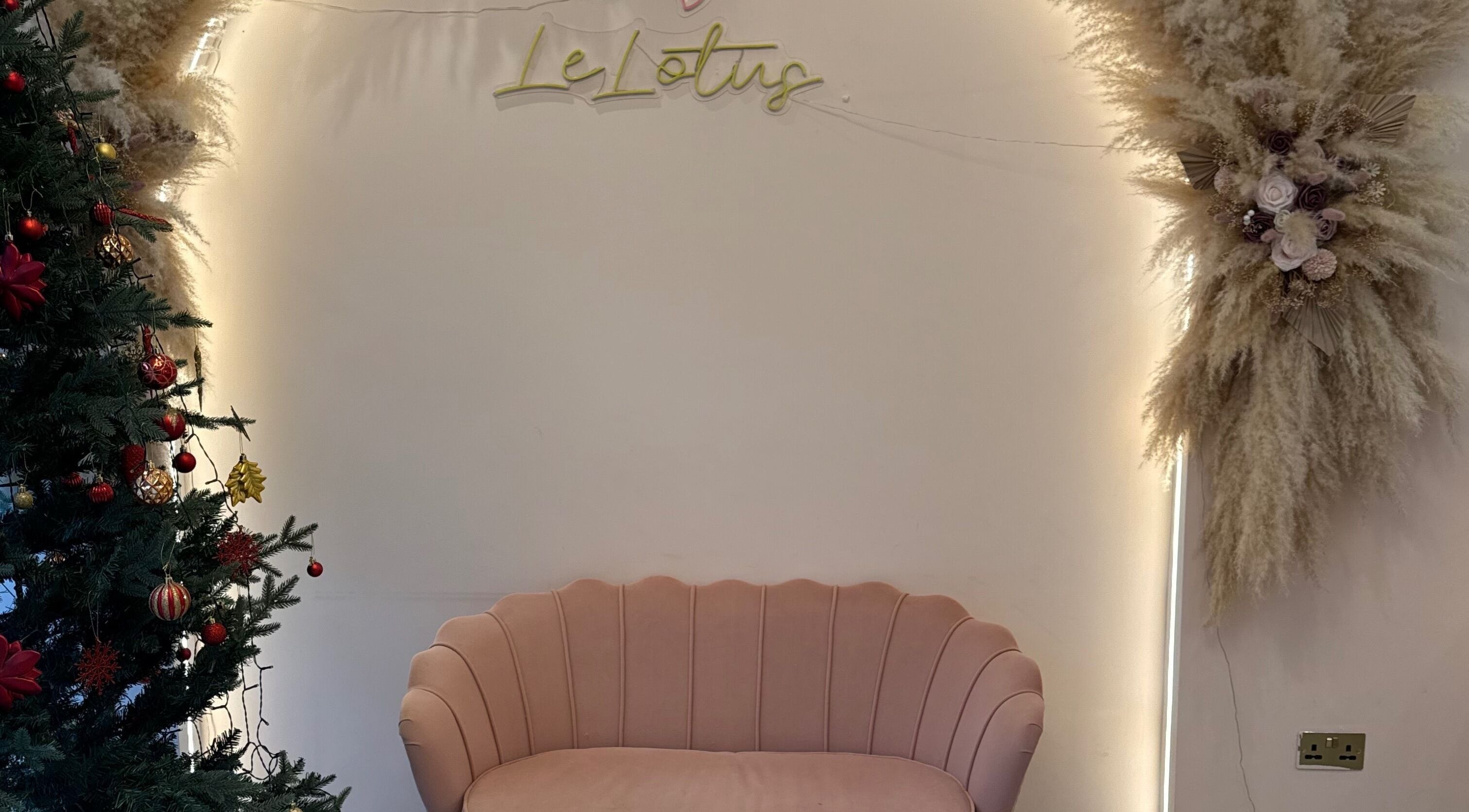 Chic lounge at 107 Putney high street SW15 1SS, London, England, GB with festive decor and pink seating.