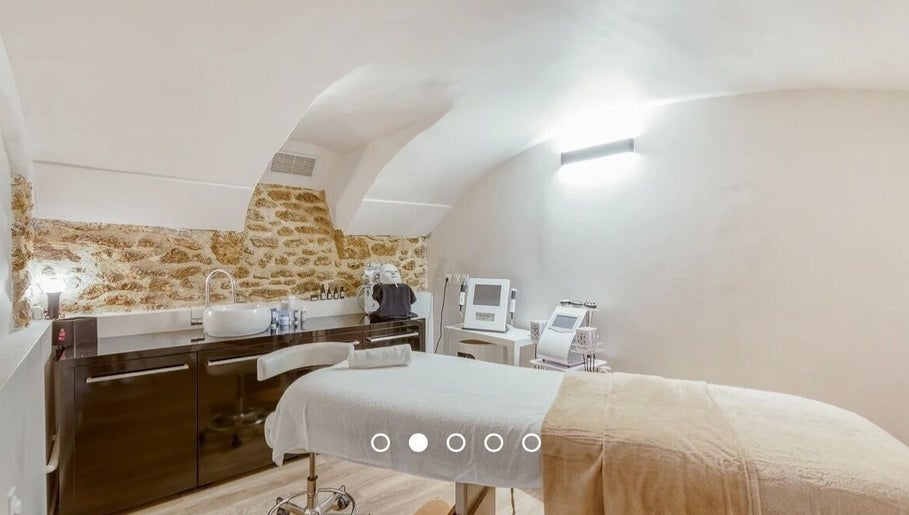 Salle de soins élégante au Centre New Face, Paris, Île-de-France, FR avec murs en pierre apparente.