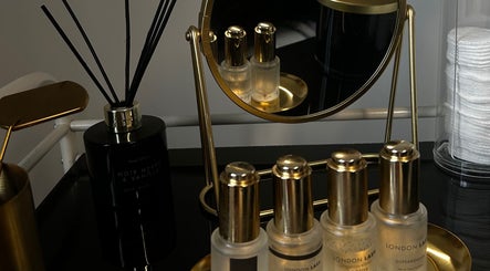Elegant vanity setup at De Luxe Beaute, Nottingham, England, GB with luxury beauty products and mirror.