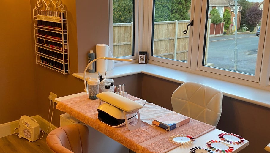 Stylish nail station at Nu- nails and beauty, Hemel Hempstead, England, GB with cozy seating and polish display.
