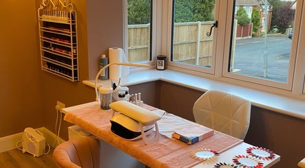 Stylish nail station at Nu- nails and beauty, Hemel Hempstead, England, GB with cozy seating and polish display.