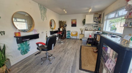 Elegant interior of Hairbyanna salon, Limerick, County Clare, IE showcasing styling stations and hair products.