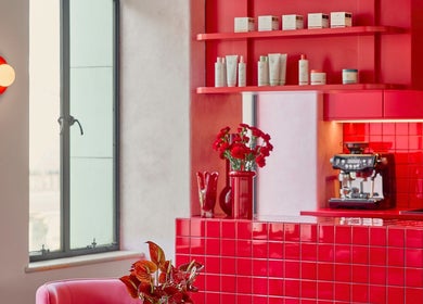 Chic red interior at Ginger Rose, Melbourne, Victoria, AU, featuring modern decor and beauty products on display.