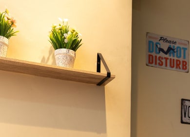 Decoración en Gous Barbershop en San Marcos, San Marcos, GT con plantas en estante y señal de 'Do Not Disturb'.
