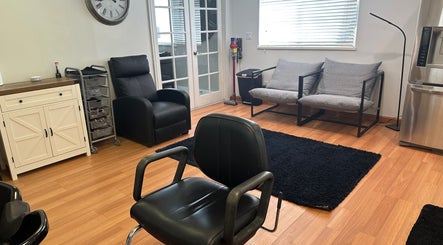 Modern salon seating area at Laurrie’s Hair Design, Kaysville, Utah, US with stylish chairs and decor.