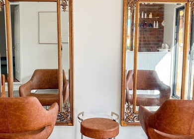 Elegant salon chairs and mirrors at Renz Hair Studio in Melbourne, Victoria, AU.