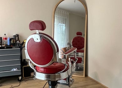 Classic red barber chair at B The Barber, Perth, Western Australia, AU, reflecting elegance in vintage style.