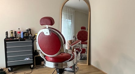 Classic red barber chair at B The Barber, Perth, Western Australia, AU, reflecting elegance in vintage style.