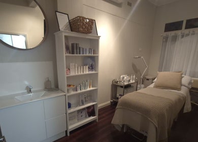 Serene treatment room at SK Dermal, Romsey, Victoria, AU, featuring a cozy bed and elegant decor.