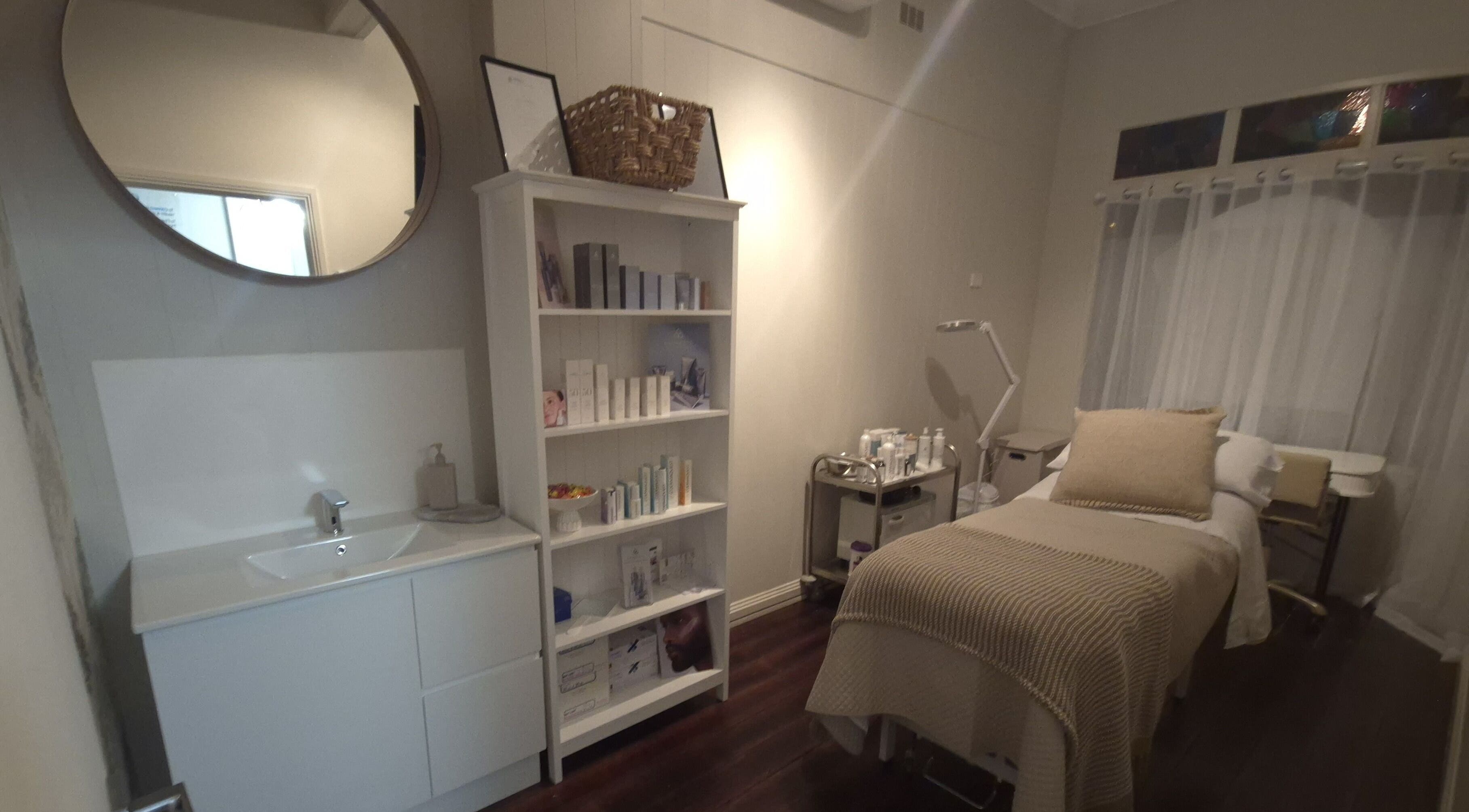 Serene treatment room at SK Dermal, Romsey, Victoria, AU, featuring a cozy bed and elegant decor.