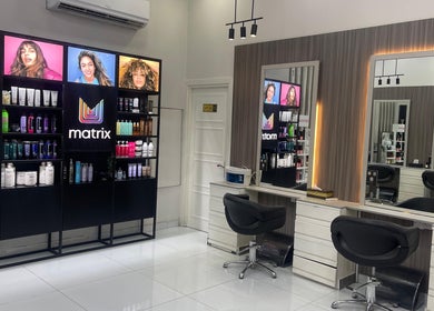 Elegant interior of Dreams Salon, Dubai, AE showcasing modern chairs and premium hair products.
