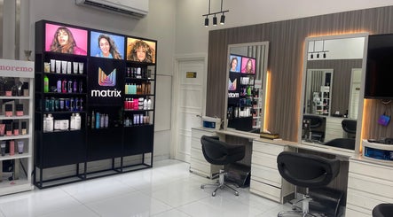 Elegant interior of Dreams Salon, Dubai, AE showcasing modern chairs and premium hair products.