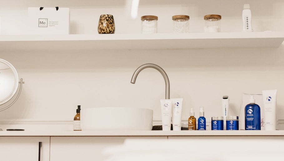 Skincare products at Pascale Dermal Aesthetics, Stellenbosch, Western Cape, ZA, elegantly arranged by a sink.