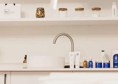 Skincare products at Pascale Dermal Aesthetics, Stellenbosch, Western Cape, ZA, elegantly arranged by a sink.