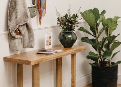 Cozy entrance at Pascale Dermal Aesthetics, Stellenbosch, featuring elegant decor and a lush plant.