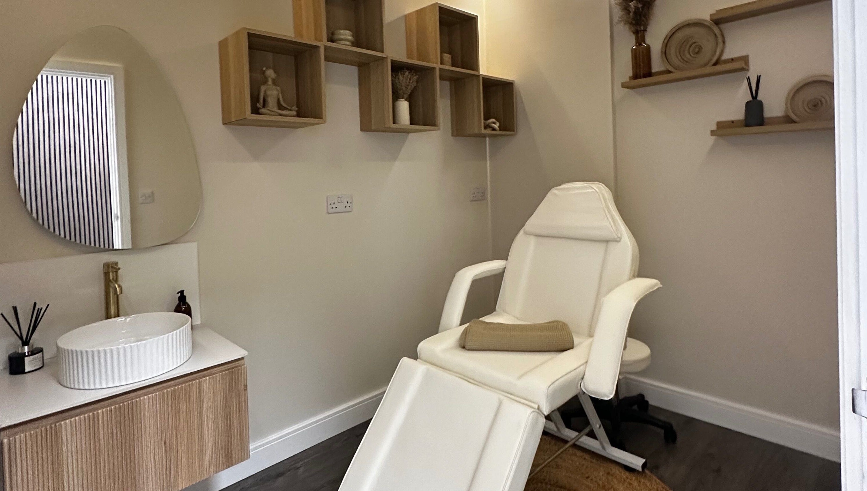 Relaxing massage room at Rituals Holistic Massage in Cardiff, Wales, GB with a comfortable chair and calming decor.