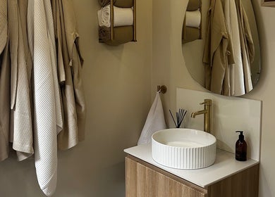 Luxurious bathroom at Rituals Holistic Massage, Cardiff, Wales, GB, featuring robes and a stylish vanity.