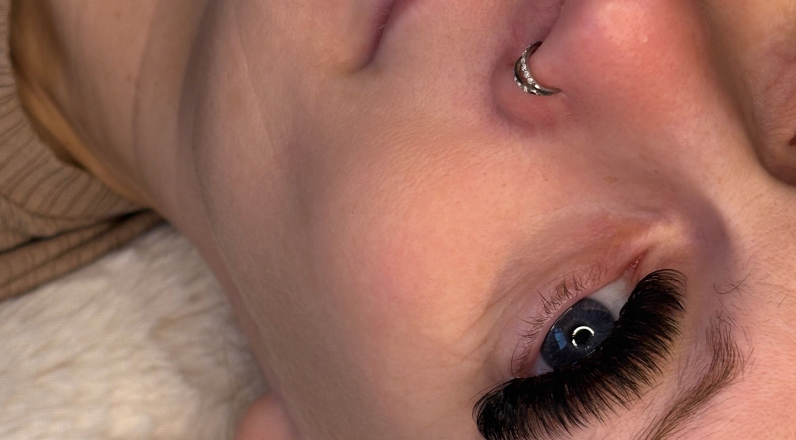 Close-up of lush eyelashes with nose piercing at By Georgia Rose, Stoke-on-Trent, England, GB.