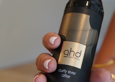 Person holding hair product at The Luxe Hair Spa, Barcelona, Catalunya, ES.