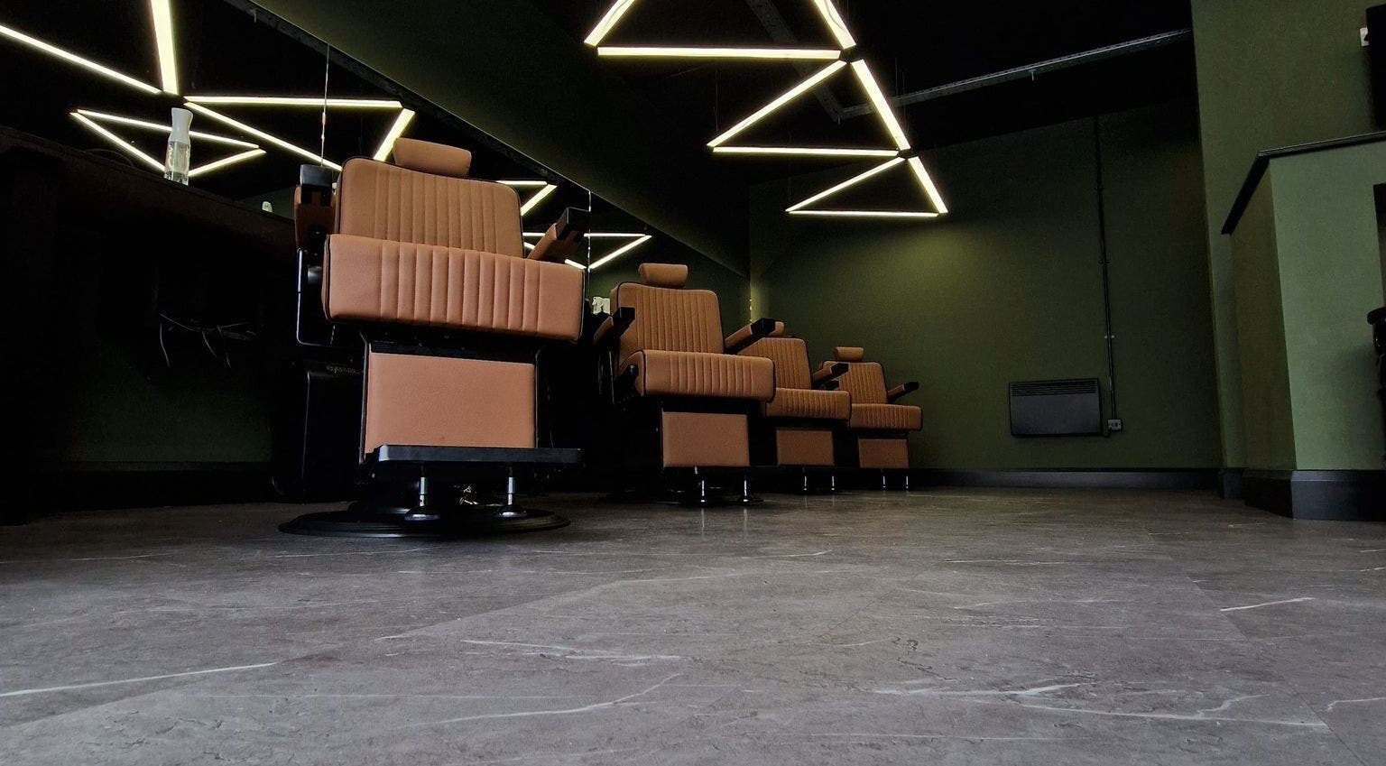 Modern barber chairs at BarberHouse44, Letterkenny, County Donegal, IE, showcasing sleek, stylish design.