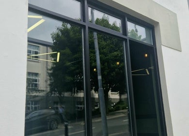 Glass facade of BarberHouse44 in Letterkenny, County Donegal, IE showcasing sleek design.