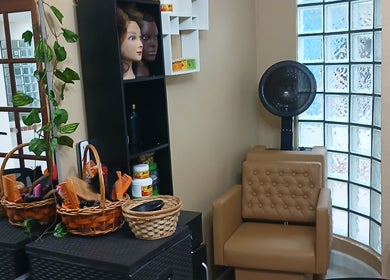 Cozy interior of Infinite Finesse by Chanel in Saint George's, GD, featuring styling tools and decor.