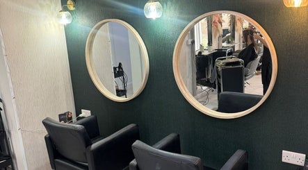 Elegant salon interior at Alex Jamieson Hairdressing, Knottingley, England, GB with stylish mirrors and seating.