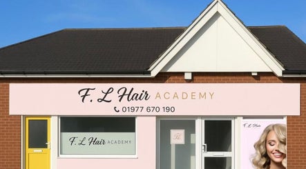 Exterior of Alex Jamieson Hairdressing in Knottingley, England, GB with stylish signage and bright facade.