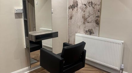 Modern salon chair and mirror setup at Alex Jamieson Hairdressing in Knottingley, England, GB.
