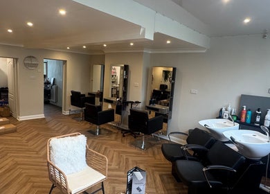 Chic interior of Alex Jamieson Hairdressing in Knottingley, England, GB with modern styling stations.
