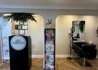 Elegant interior of Alex Jamieson Hairdressing in Knottingley, England, featuring a stylish reception and salon chair.