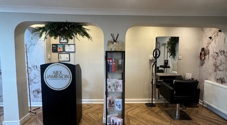 Elegant interior of Alex Jamieson Hairdressing in Knottingley, England, featuring a stylish reception and salon chair.