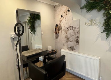Modern styling chair at Alex Jamieson Hairdressing, Knottingley, England, GB, with elegant decor.
