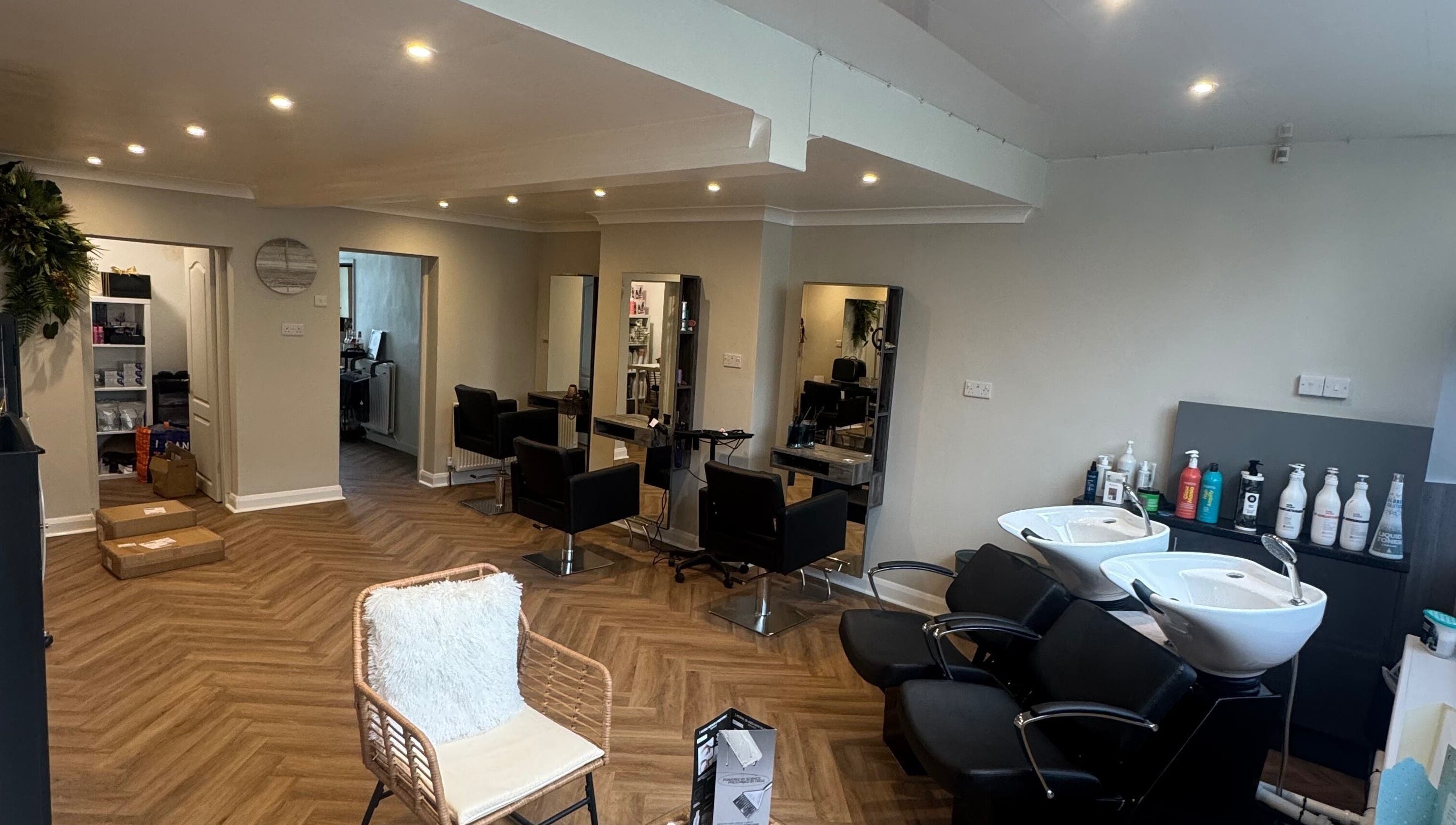 Modern salon interior at Alex Jamieson Hairdressing in Knottingley, England, GB with sleek styling stations.