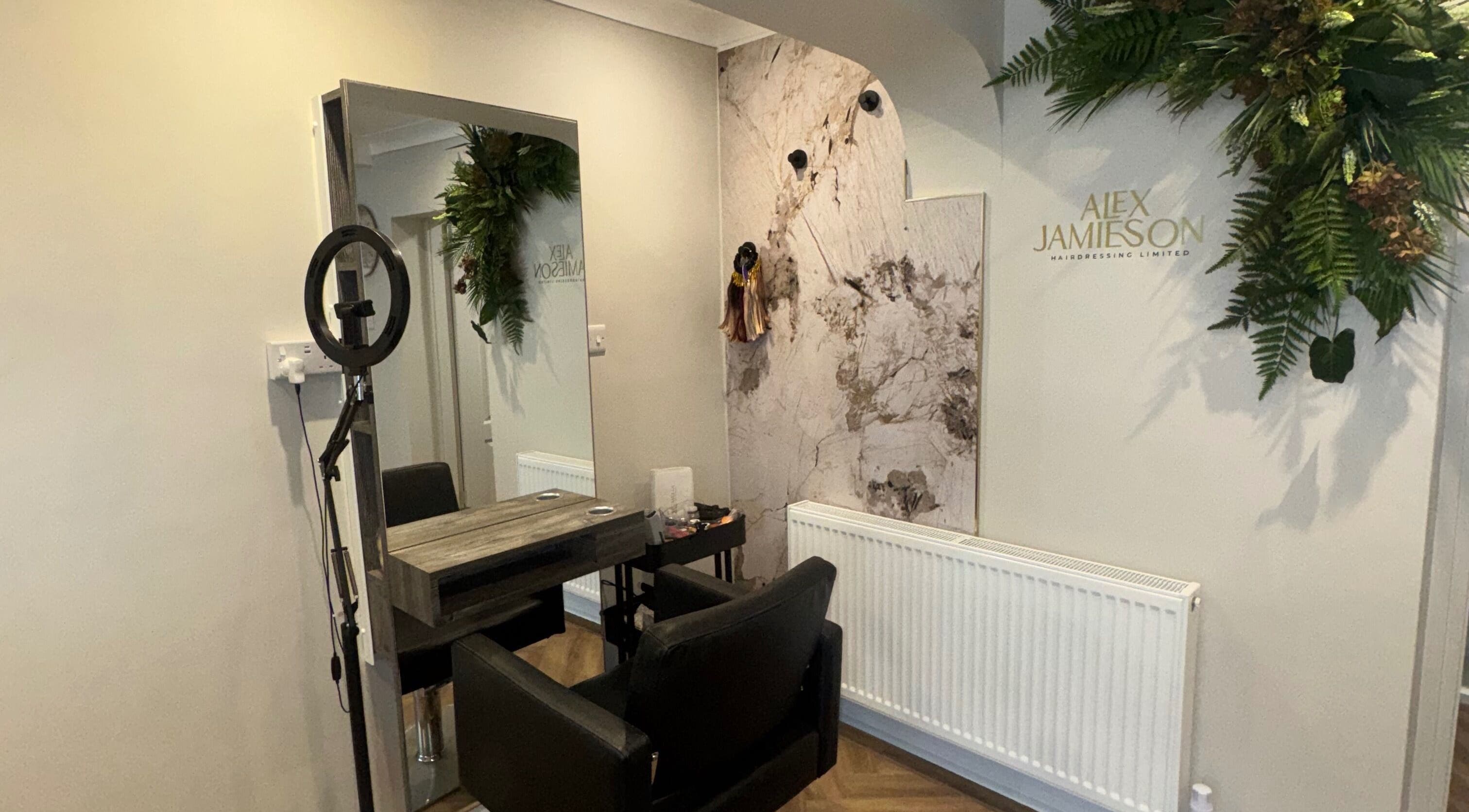 Stylish salon station at Alex Jamieson Hairdressing in Knottingley, England, GB, featuring elegant decor and seating.