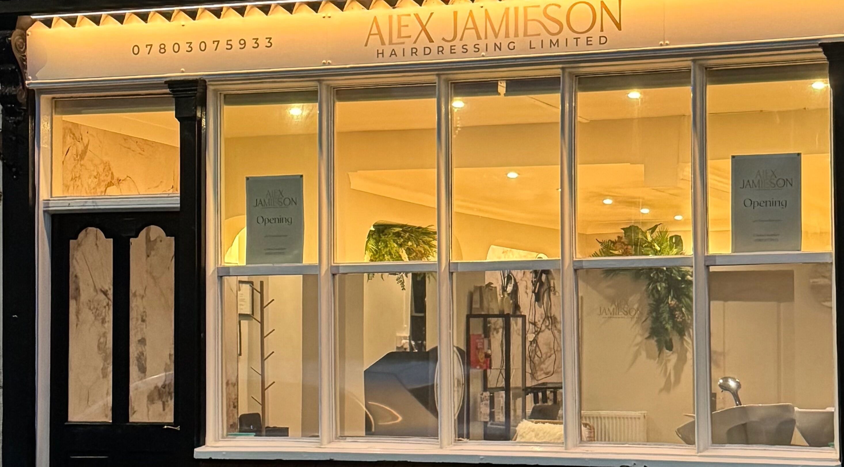 Front view of Alex Jamieson Hairdressing in Knottingley, England, GB featuring warmly lit interior.