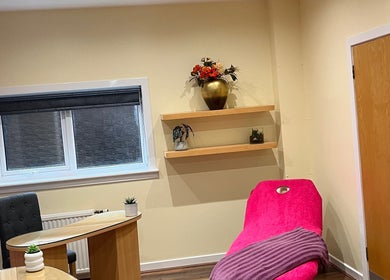 Chic treatment room at Nailsbyserenastrachan featuring a pink chair in Bathgate, Scotland, GB.
