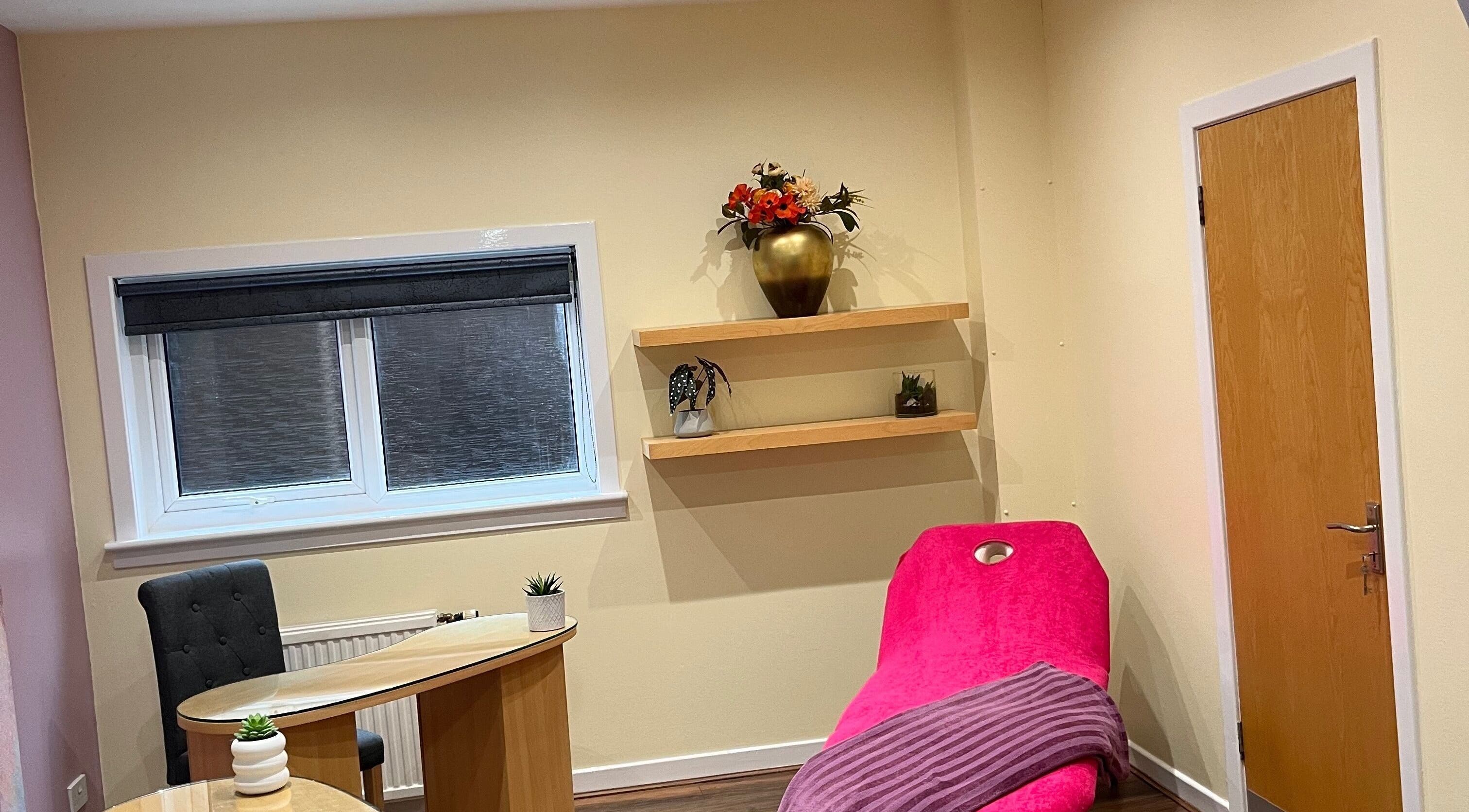 Chic treatment room at Nailsbyserenastrachan featuring a pink chair in Bathgate, Scotland, GB.