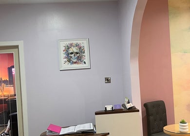 Chic reception area at Nailsbyserenastrachan, Bathgate, Scotland, GB, featuring colorful wall art and stylish decor.
