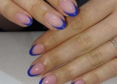 Elegant blue tipped nails by Chloe Cross Nail Artist, Barnsley, England, GB. Perfect blend of style and sophistication.