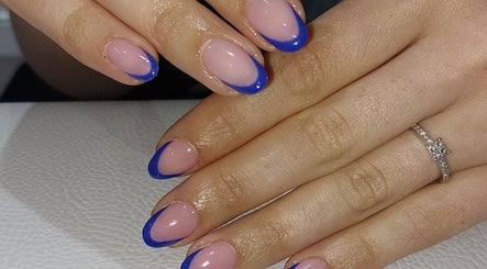 Elegant blue tipped nails by Chloe Cross Nail Artist, Barnsley, England, GB. Perfect blend of style and sophistication.
