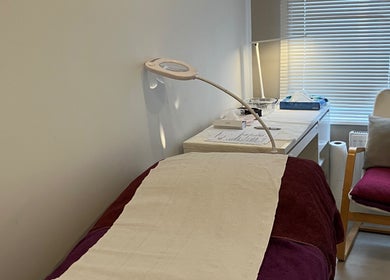 A cozy treatment room at Delight Laser Spa, New Barnet, England, GB, featuring a comfortable bed and serene lighting.