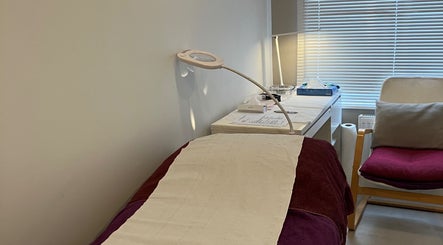 A cozy treatment room at Delight Laser Spa, New Barnet, England, GB, featuring a comfortable bed and serene lighting.