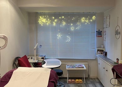 A tranquil spa room at Delight Laser Spa, New Barnet, England, GB with cozy decor and ambient lighting.
