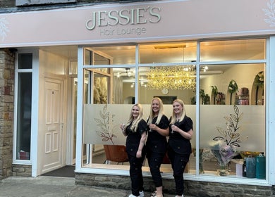 Front view of Jessie's Hair Lounge with smiling staff in Whaley Bridge, England, GB.