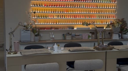 Manicure station with vibrant nail polish display at The Nail Company Whiteley, Whiteley, England, GB.