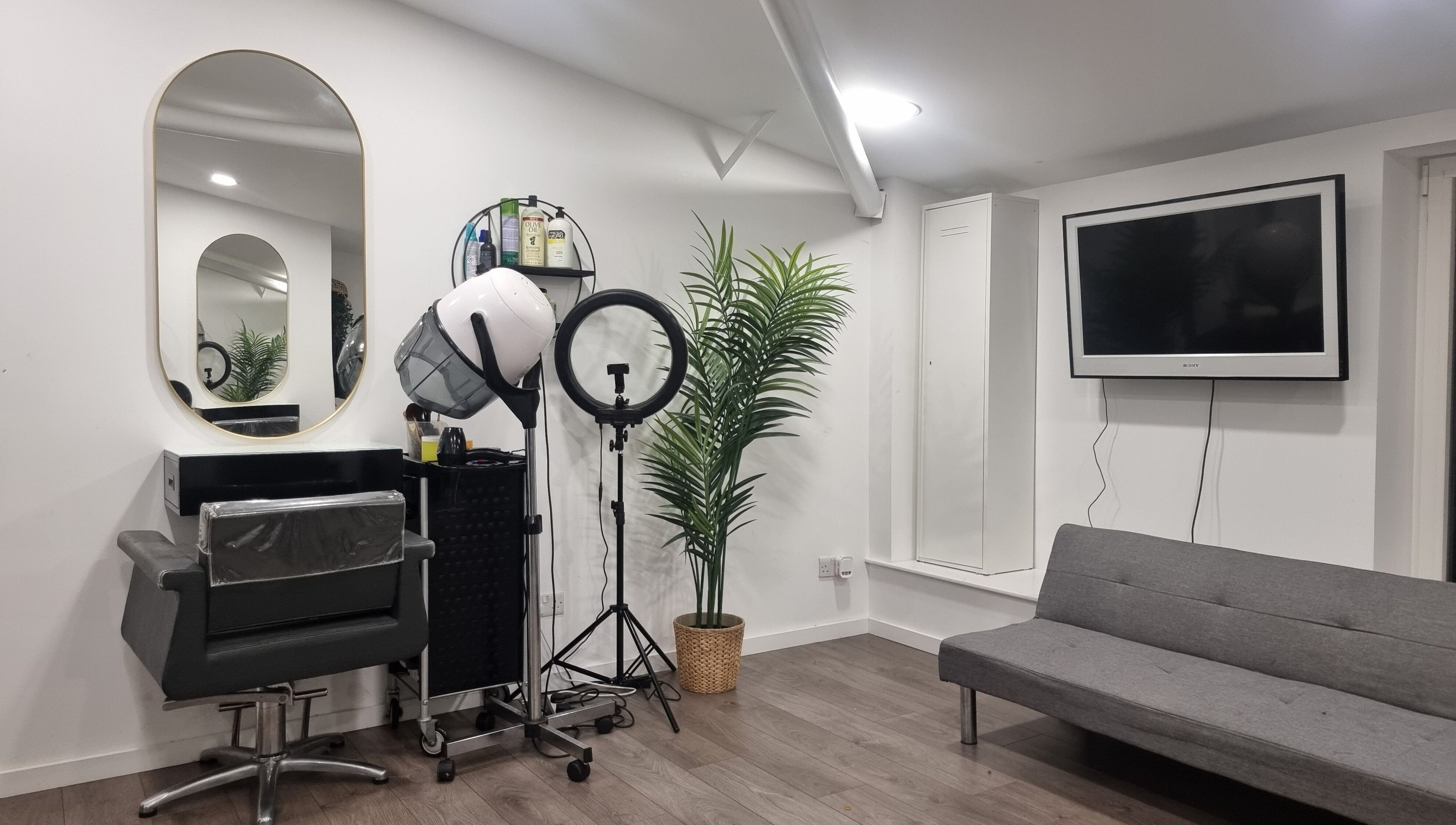 Styling station at Devinerootz Salon, Grays, England, GB with modern decor and sleek furnishings.