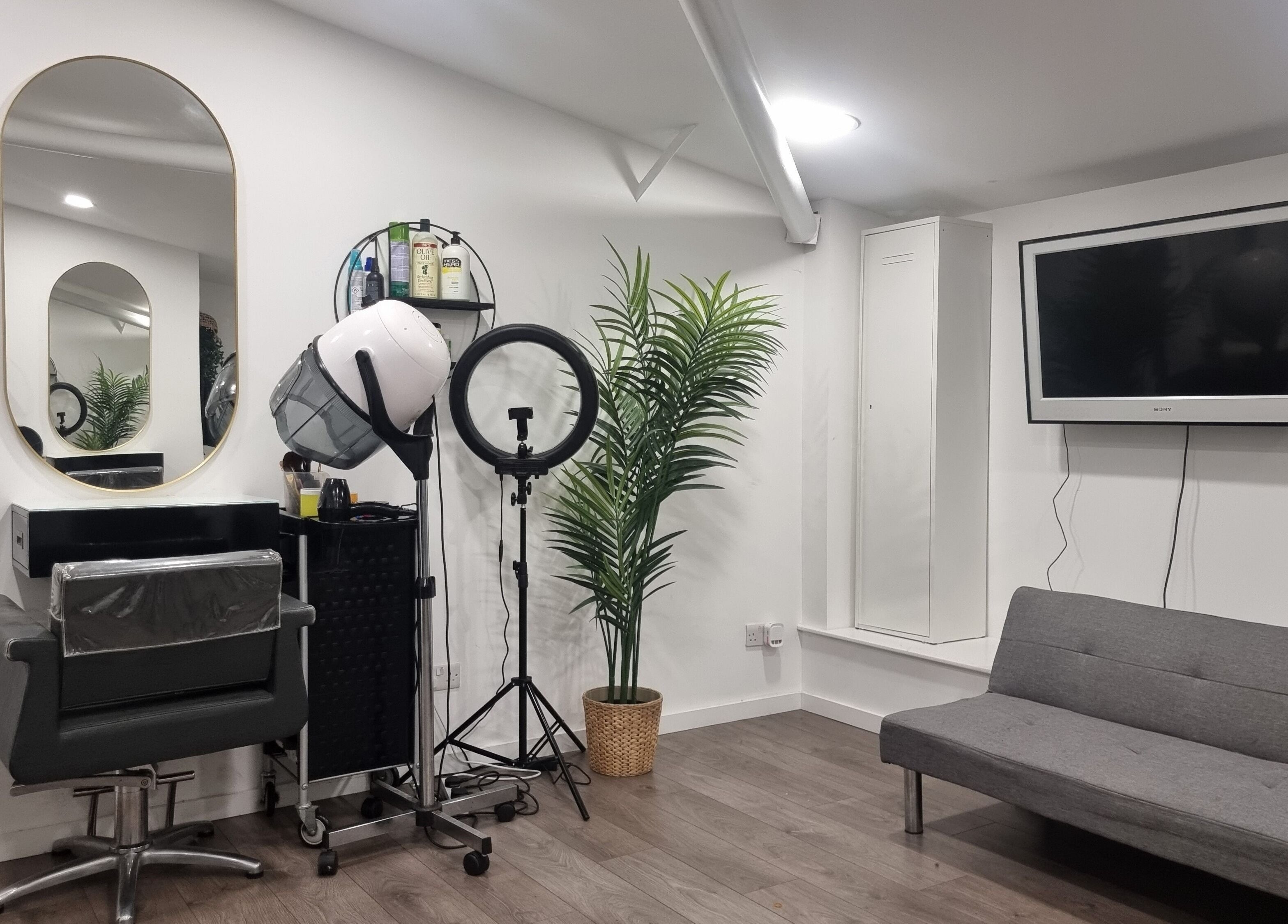 Styling station at Devinerootz Salon, Grays, England, GB with modern decor and sleek furnishings.