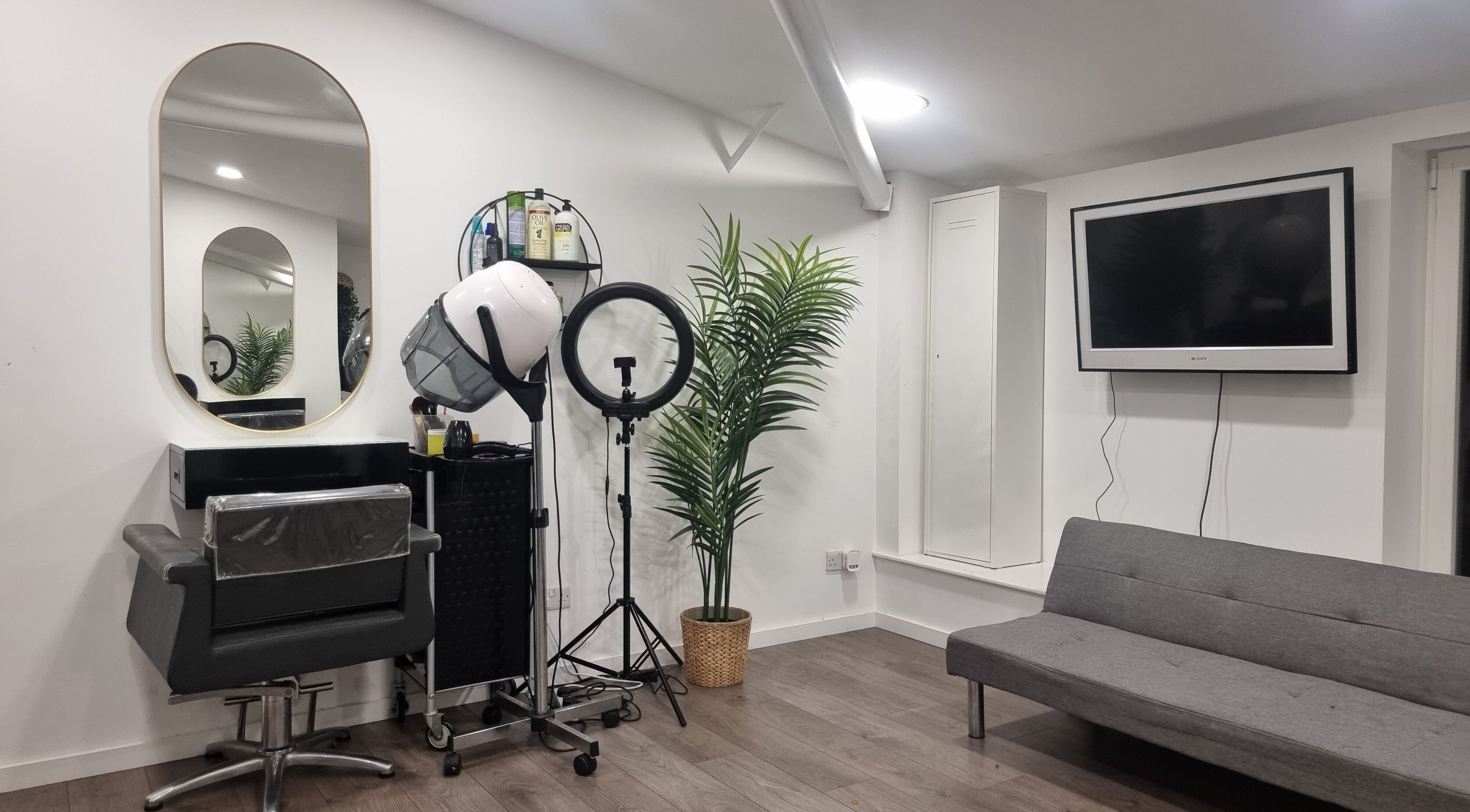 Styling station at Devinerootz Salon, Grays, England, GB with modern decor and sleek furnishings.