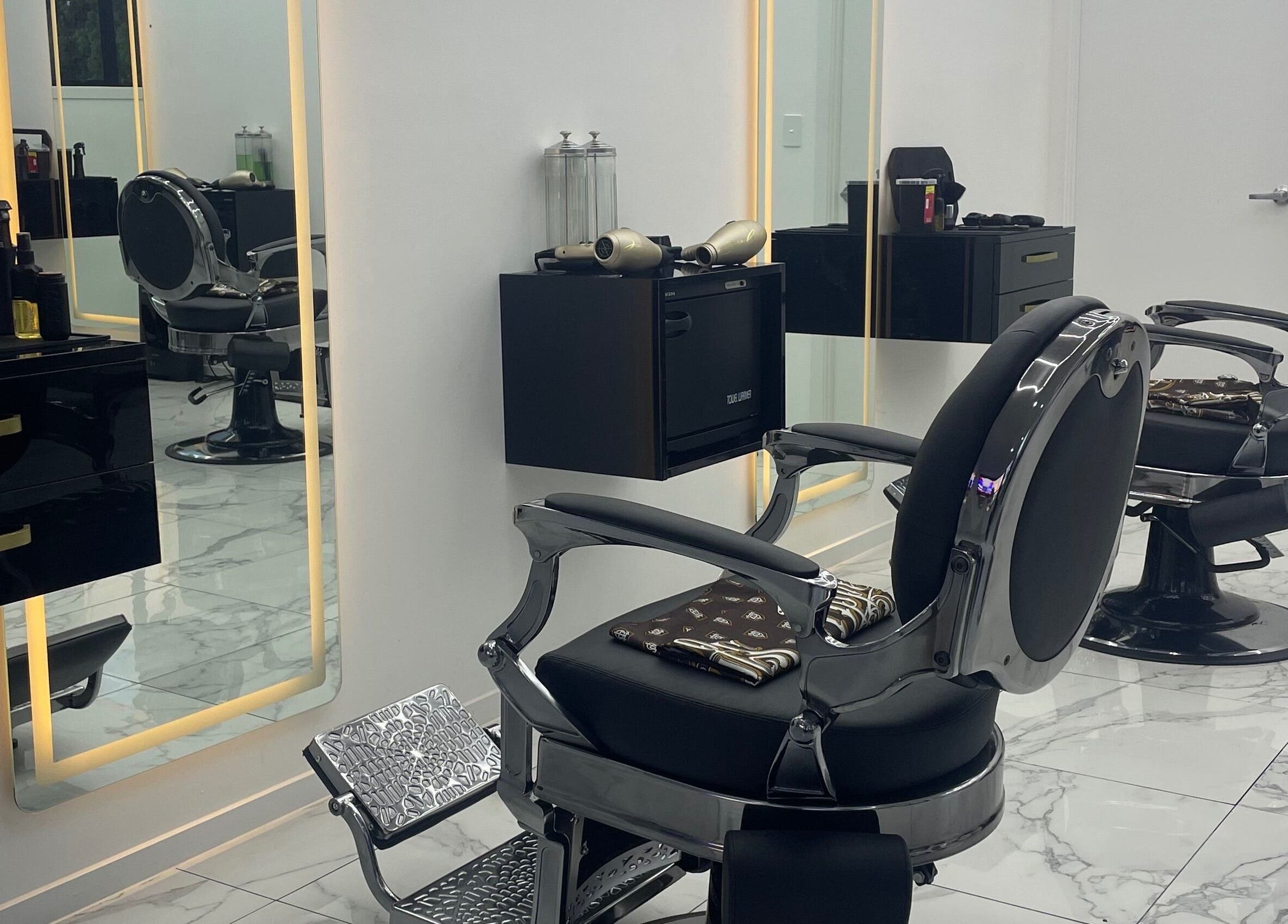 Elegant, modern barber chairs at Crwn Barbers in Auckland, Auckland, NZ with stylish decor and lighting.